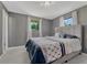 Comfortable bedroom with gray walls, carpet, and two windows offering natural light at 7479 Pierce St, Arvada, CO 80003