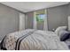This bedroom features soft gray walls, a comfortable bed, and a window with natural light at 7479 Pierce St, Arvada, CO 80003