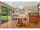 Bright dining area with a wooden table, chairs, chandelier, and view to the lawn at 7479 Pierce St, Arvada, CO 80003
