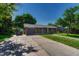 Charming brick home featuring a one-car garage and well-maintained lawn, creating appealing curb appeal at 7479 Pierce St, Arvada, CO 80003
