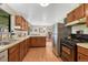 Bright kitchen features stainless steel refrigerator and view to the dining area at 7479 Pierce St, Arvada, CO 80003