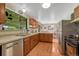 This kitchen features wood cabinets, a stainless steel dishwasher, and plenty of natural light at 7479 Pierce St, Arvada, CO 80003