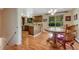 Spacious living area with view to the kitchen and dining area, featuring hardwood floors at 7479 Pierce St, Arvada, CO 80003