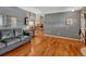 Bright living room with hardwood floors, gray walls, and comfortable seating arrangement in a cozy setting at 7479 Pierce St, Arvada, CO 80003