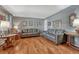 Comfortable living room featuring hardwood floors, soft gray walls, and stylish decor under natural light at 7479 Pierce St, Arvada, CO 80003