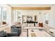 Open-concept living room featuring hardwood floors, exposed beam, and lots of natural light at 20 Viking Dr, Cherry Hills Village, CO 80113