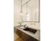 Modern bathroom with stone countertop, minimalist mirror, and pendant lighting at 20 Viking Dr, Cherry Hills Village, CO 80113