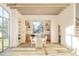 Bright dining area with beamed ceilings and kitchen view at 20 Viking Dr, Cherry Hills Village, CO 80113
