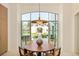 Eat-in kitchen with view through arched windows of the backyard at 20 Viking Dr, Cherry Hills Village, CO 80113