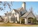 Side view of beautiful residence displaying classic architecture, lush yard, and attached car port at 20 Viking Dr, Cherry Hills Village, CO 80113