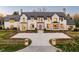 Elegant home with a cobblestone driveway, manicured lawn and stone accents around the entryway at 20 Viking Dr, Cherry Hills Village, CO 80113