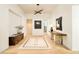 Spacious foyer with rustic table and a view to another room at 20 Viking Dr, Cherry Hills Village, CO 80113