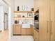 Charming kitchen with custom cabinetry and stylish décor on illuminated shelving at 20 Viking Dr, Cherry Hills Village, CO 80113