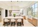 Spacious kitchen with eat-in island, stone counters and backsplash, and pendant lighting at 20 Viking Dr, Cherry Hills Village, CO 80113