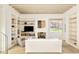 Cozy living room with fireplace, built-in shelves, and ample natural light at 20 Viking Dr, Cherry Hills Village, CO 80113