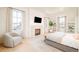 Bright and airy main bedroom with a fireplace, TV, and natural light at 20 Viking Dr, Cherry Hills Village, CO 80113