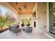 Inviting covered outdoor living area features a stone fireplace and comfortable seating at 20 Viking Dr, Cherry Hills Village, CO 80113