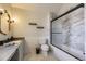 Bathroom featuring a marble shower, sleek fixtures, and a classic white tiled backsplash at 286 Warwick Pl, Castle Pines, CO 80108