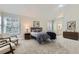 This cozy bedroom features neutral tones, large windows, and a view to the ensuite bathroom at 286 Warwick Pl, Castle Pines, CO 80108