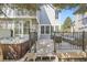 Entertaining deck with a hot tub and comfortable seating area, perfect for outdoor relaxation at 286 Warwick Pl, Castle Pines, CO 80108