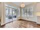 Bright dining area with hardwood floors, designer lighting and access to the outdoor deck at 286 Warwick Pl, Castle Pines, CO 80108