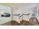 Hallway featuring hardwood floors, an open bedroom view, and access to a secondary room at 286 Warwick Pl, Castle Pines, CO 80108