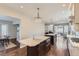 This kitchen features two islands, stainless appliances, wood floors, and pendant lighting at 286 Warwick Pl, Castle Pines, CO 80108