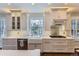 A beautifully designed kitchen with a farmhouse sink, stainless steel appliances, and custom cabinetry at 286 Warwick Pl, Castle Pines, CO 80108