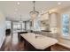 This kitchen has a large island, stainless appliances, pendant lighting, wood floors and lots of counter space at 286 Warwick Pl, Castle Pines, CO 80108