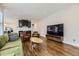 This living room has hardwood floors, neutral walls and is adjacent to the modern kitchen at 286 Warwick Pl, Castle Pines, CO 80108