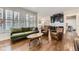 Bright and airy living room features hardwood floors, a modern sofa and a view to the kitchen at 286 Warwick Pl, Castle Pines, CO 80108