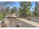Stone walkway surrounded by mature trees and rock gardens showing the property's well-maintained landscape at 286 Warwick Pl, Castle Pines, CO 80108