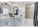 Modern bathroom with double vanity and soaking tub at 5601 E Iowa Ave, Denver, CO 80224