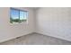 Simple bedroom with patterned wall and carpet at 5601 E Iowa Ave, Denver, CO 80224