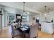 Open concept dining area with hardwood floors and modern lighting at 5601 E Iowa Ave, Denver, CO 80224