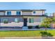 Modern two-story home with gray and white exterior, stone accents, and a small lawn at 5601 E Iowa Ave, Denver, CO 80224