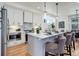 Modern kitchen with white cabinets and a herringbone backsplash at 5601 E Iowa Ave, Denver, CO 80224