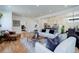 Open concept living room with kitchen view and hardwood floors at 5601 E Iowa Ave, Denver, CO 80224