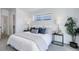 Main bedroom with a queen-size bed and plenty of natural light at 5601 E Iowa Ave, Denver, CO 80224