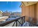 Balcony with iron railing and seating overlooks a snowy town square under a clear blue sky at 505 S Main St # 1313, Breckenridge, CO 80424