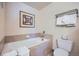 Cozy bathroom featuring a pristine white tub with tile surround, toilet, and towel rack at 505 S Main St # 1313, Breckenridge, CO 80424