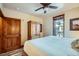 Bright bedroom featuring wood trim, a ceiling fan, and a comfortable bed near the window at 505 S Main St # 1313, Breckenridge, CO 80424