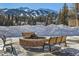 Picturesque outdoor fire pit area with benches and views of the snowy mountain landscape at 505 S Main St # 1313, Breckenridge, CO 80424