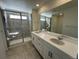 Bright bathroom with double vanity, large mirror, and walk-in shower at 17719 Prairie Peak Trl, Parker, CO 80134