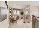 Comfortable loft space with a desk, chair, floor lamp, and natural light creating an inviting ambiance at 17719 Prairie Peak Trl, Parker, CO 80134