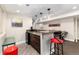 Entertainer's basement wet bar features warm wood tones and stylish pendant lighting at 2334 Lowell Blvd, Denver, CO 80211