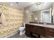 Bathroom with brown vanity, neutral tile and yellow patterned shower curtain at 2334 Lowell Blvd, Denver, CO 80211