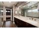 Elegant bathroom with dual sinks, granite counters, and a glimpse into the bedroom at 2334 Lowell Blvd, Denver, CO 80211