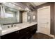 Elegant bathroom featuring dual sinks, granite countertops, and a large mirror at 2334 Lowell Blvd, Denver, CO 80211