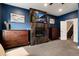 Modern bedroom with fireplace, TV, dark wood furniture, and neutral carpet at 2334 Lowell Blvd, Denver, CO 80211